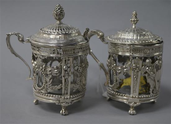 Two late 19th century German Hanau? silver mustard pots and two spoons.
